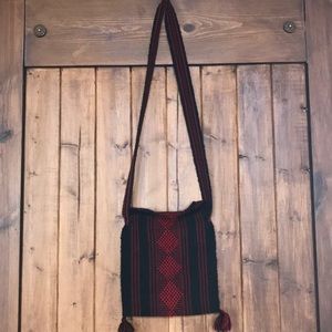 Woman’s handmade red and black woven purse